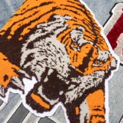 Amiri Varsity Tiger Straight Jean - Vintage Indigo -Urban Fashion Sales Varsity Tiger Straight Jean Vintage Indigo PF23MDF016 875 08 16 23 Feature KN 7 scaled